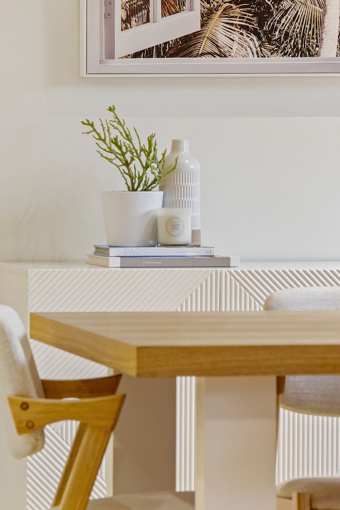 Elegant minimalist dining room with wooden table and decor elements for a contemporary look.