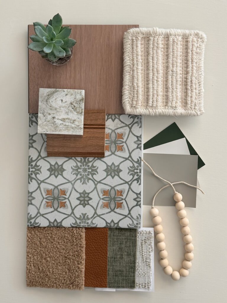 Interior design material palette with decorative patterned tile, creamy quartz, warm wood, woven textiles, finishes, and a succulent.