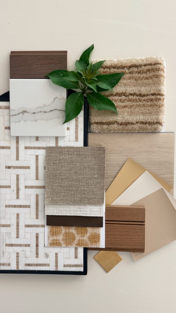 Interior design material palette with white geometric tile, warm oak wood, woven neutral textiles, soft paint samples, natural stone, greenery, and walnut wood accents.