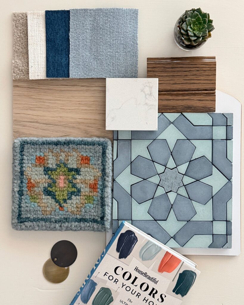 Interior design material palette featuring geometric aqua and blue tile, white quartz, warm woods, soft blue and neutral textiles, succulent, and book.
